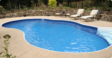 kidney shaped in-ground pool with retaining wall in Maryland