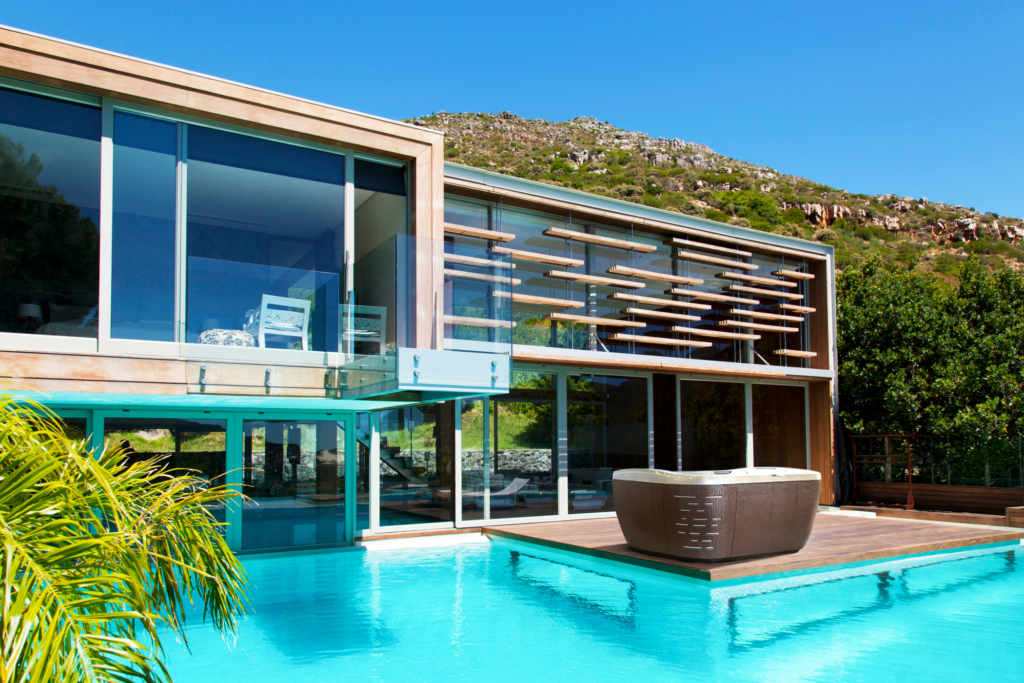 Outdoor Jacuzzi Hot Tub in a modern backyard with an inground pool.